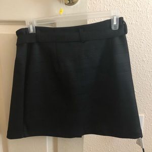 Black skirt with belt attached. Kinda plaid.